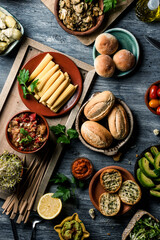 table full of vegan snacks, dips and side dishes