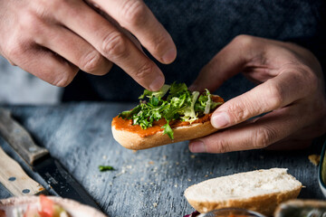 young man prepares a vegan appetizer