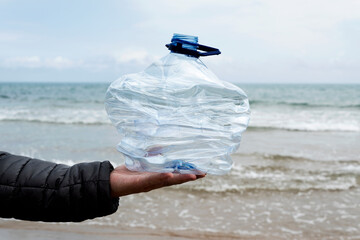 man with a used plastic bottle in his hand