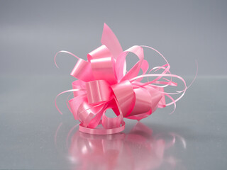 bows from a motley colorful ribbon on a gray background
