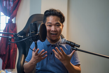 Portrait of young Asian man  with two microphone for singing or voice over or streamer with happy face. Selective focus. 