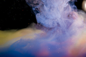 Creating abstract art with acrylic paints in water. making surreal clouds out of paints. colorful backgrounds.