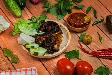 Ayam Penyet / grilled chicken, this food is a traditional food from Java made from grilled chicken with spicy shrimp paste.