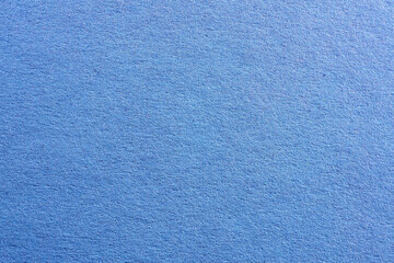 Blue colored paper with strong structure as a background, photographed in the studio