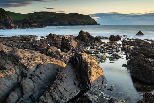 Evening sunlight on the rocky shores of Hope Cove, Devon, England, United Kingdom