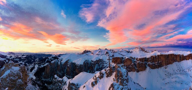 Pink clouds in the sky at sunset over Gran Cir and Odle mountains covered with snow in winter, Dolomites, South Tyrol, Italy