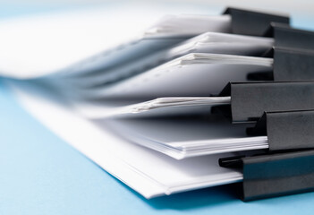 close-up stacking report paper office working paper, blue color background