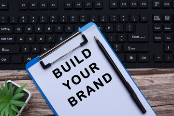 Text a a blue clipboard on top of a black keyboard