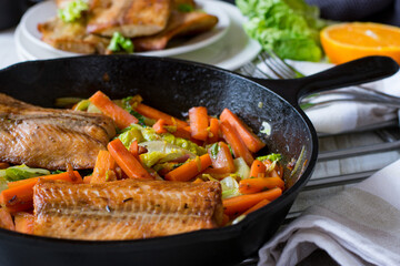 Low carb meal with fried salmon, cabbage and vegetable