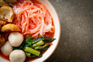 small flat rice noodles with fish balls and shrimp balls in pink soup, Yen Ta Four or Yen Ta Fo