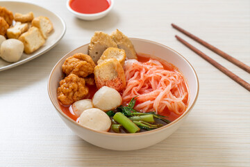 small flat rice noodles with fish balls and shrimp balls in pink soup, Yen Ta Four or Yen Ta Fo