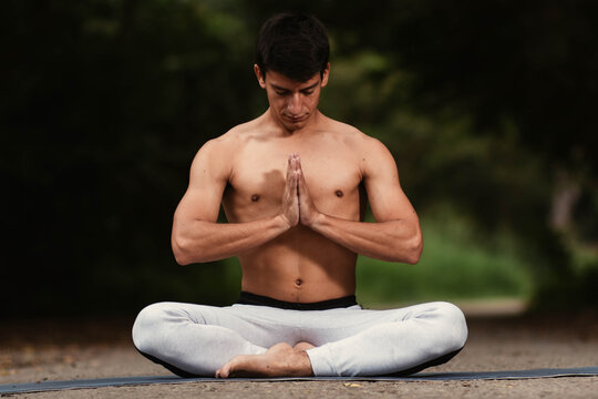 Young Latino Man Meditating And Practicing Yoga In The Forest