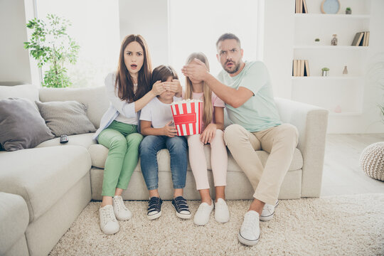 Full Size Photo Of Stressed Family Mom Dad Close Two Kids Eyes Watch Tv Sit On Sofa Wear T-shirts Trousers At Home