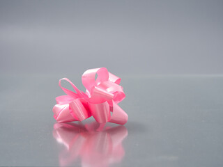 bows from a motley colorful ribbon on a gray background