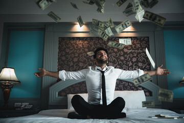 Successful businessmen celebrates success under money rain falling down dollar bills . Finances...