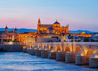 View over Roman Bridge of Cordoba and Guadalquivir River towards the Mosque Cathedral, dusk, UNESCO World Heritage Site, Cordoba, Andalusia, Spain