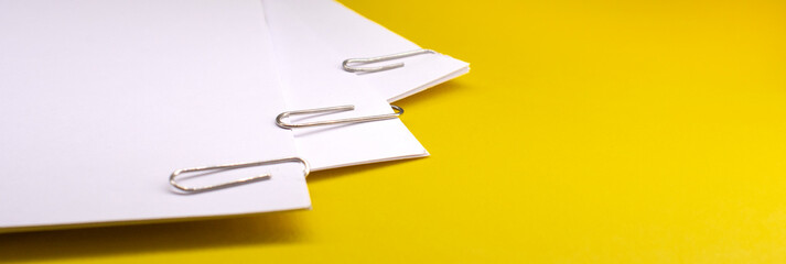 metal paper clips attached to a blank white paper