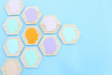 wooden blocks with people icon over blue background, building a strong team, human resources and management concept