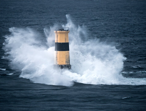 Waves crash on Tourelle de la Plate Lighthouse, Pointe du Raz, Finistere, Brittany, France
