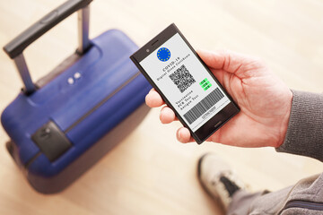 Mobile phone with digital green certificate of vaccination covid-19. Phone screen with information...