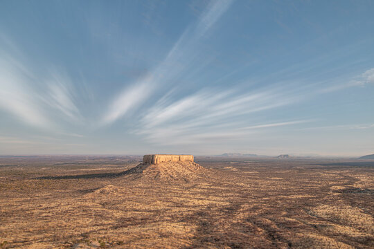 Desert landscape of Damaraland with a lonely rock in the middle, Namibia