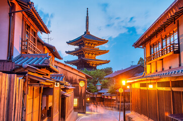 Ancient buddhist temple of Hokan-ji in old town of Kyoto in the early night. Blue glowing sky contrasts with traditional pagoda