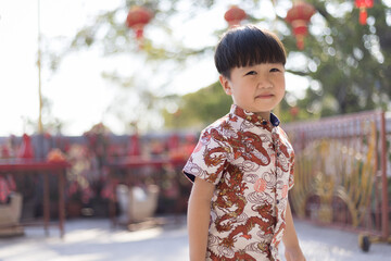 Close-up portrait of Cute Asian child smiling outdoors.