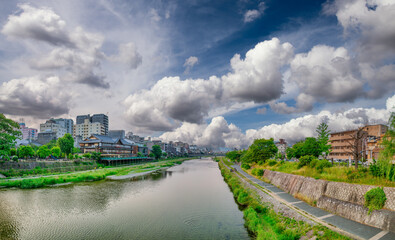 Fototapeta premium Kamo river and Kyoto skyline at sunset, Japan