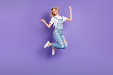 Full size profile photo of nice optimistic short hairdo blond lady jump wear white t-shirt overall isolated on violet background