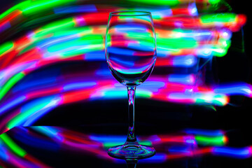 wine glass against the background of colored bright stripes
