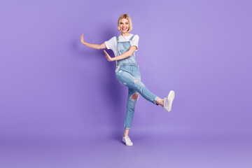 Full size photo of nice optimistic short hairdo blond lady dance wear white t-shirt overall isolated on violet background