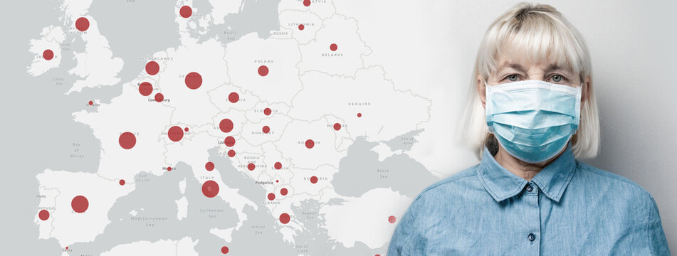 Caucasian woman in a medical mask isolated on grey wall background. Covid-19 map confirmed cases reported worldwide globally