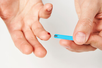 Woman with blood glucose meter, close-up
