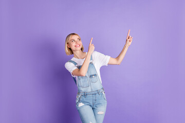 Photo of young girl happy positive smile indicate fingers empty space advert select promo isolated...