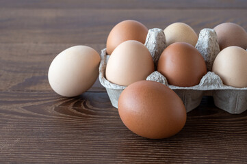 eggs in an egg box on a wooden table. Cooking. Preparing for Easter