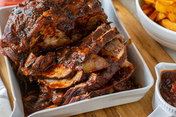 Roast pork dinner with homemade barbecue sauce and french fries