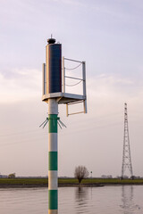 Forecast weather air pressure wind data collection mast station on the edge of river IJssel against...