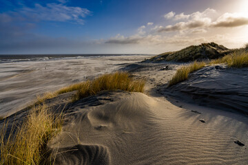 Beautiful view from a dune top on the beach and the sea during a storm.
