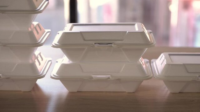  Lunch box containers on the table,  Food delivery service. White foam box stack on table. Delivery boxes arranged side by side on the table. 