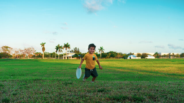 Boy playing frisbee at park