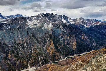 Eastern Sayans in autumn. Snow-capped peaks of Tunkinskiye Goltsy ridge. Aerial view.