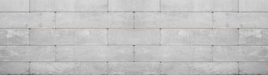 Gray retaining wall garden from concrete shuttering blocks masonry brickwork wall texture banner panorama