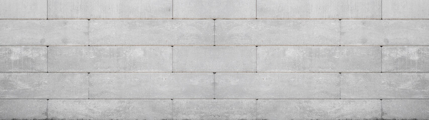 Gray retaining wall garden from concrete shuttering blocks masonry brickwork wall texture banner panorama