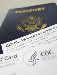 US passport with COVID-19 Vaccination Record Cards, issued by the United States CDC to indicate an individial has been vaccinated against the Coronavirus