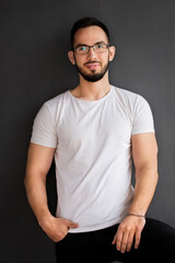 Portrait of a young handsome guy in a white t-shirt