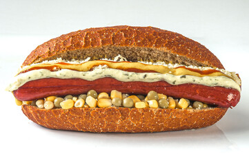 Special hot dog, sandwich served with sausage, green corn, peas and sauces on whole grain breadsauces on special bread