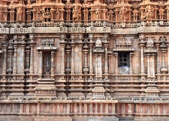 Detail of the facade of  the exterior wall of Brihadeeswarar temple in Thanjavur, Tamilnadu. Indian art of bas relief carving on the stone wall of ancient Hindu temple in Tamil nadu.