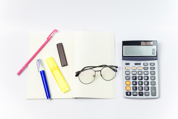 Set of Stationery office equipment or study as Glasses, pen, liquid, marker and calculator on notebook with blank center position on white background. Back to school concept. Work concept.