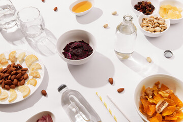 Dried fruits and nuts with sauce on white background with sunlight