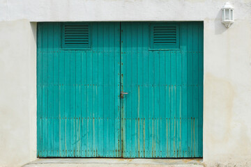 Obraz na płótnie Canvas rustic turquoise wooden garage door